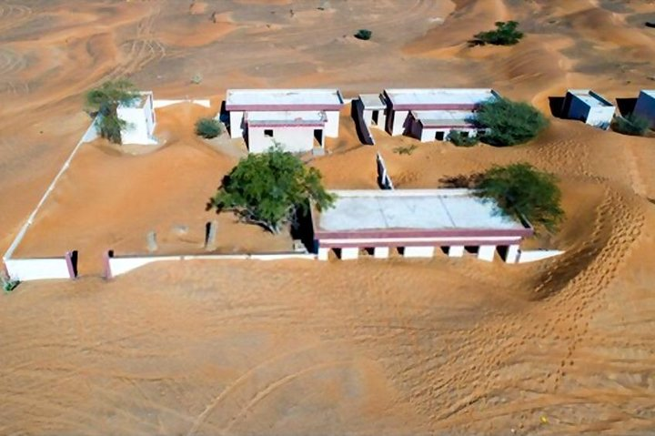 Explore the mysterious remnants of the Buried Village of Al Madam where nature's intrigue meets history in sunken structures hidden beneath the shifting sands. Uncover untold stories and timeless landscapes.